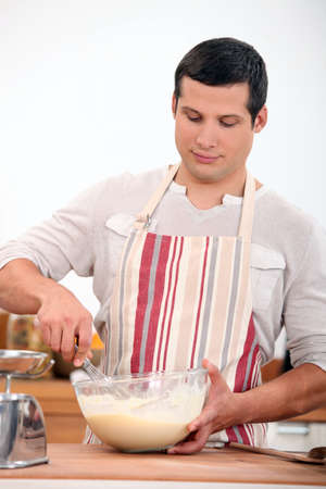 Man whisking batterの写真素材