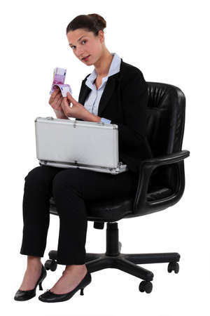 Woman counting her moneyの写真素材