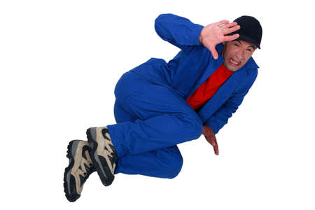 Terrified man lying on the floorの写真素材