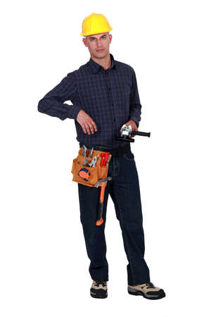 A handyman holding a power tool.の写真素材