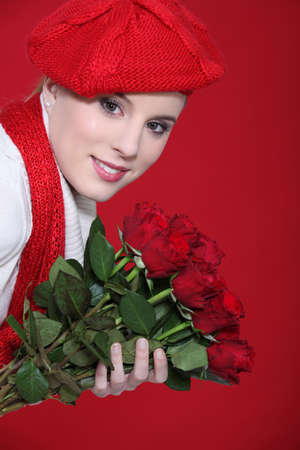 young woman holding a bouquet of rosesの写真素材