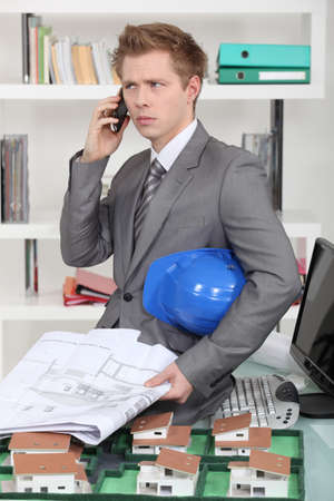 An annoyed architect talking on the phoneの写真素材
