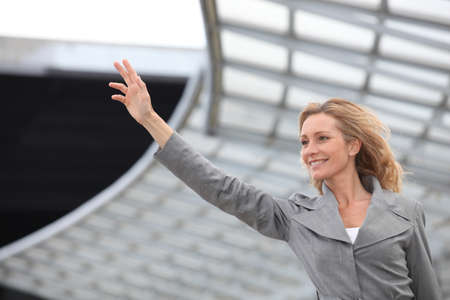 Businesswoman wavingの写真素材