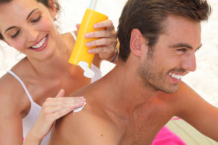 Couple applying suncreamの写真素材