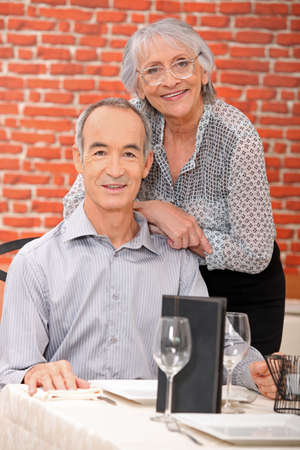 Elderly couple at restaurantの写真素材