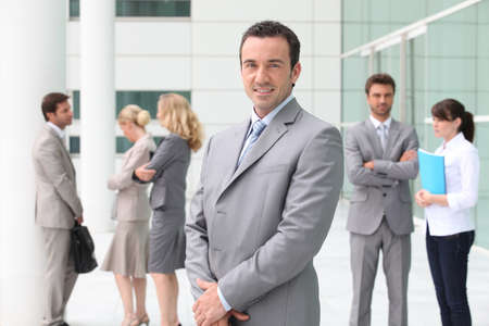 Group of business people stood outside building Group of business people stood outside building