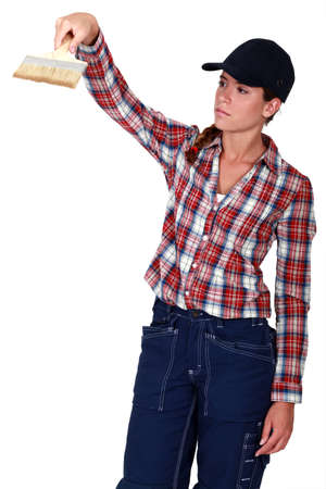 Woman using a paintbrushの写真素材