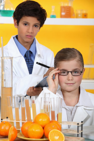 Children analysing orange juice
