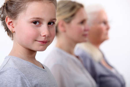 Little girl with mother and grandmother standing in line Little girl with mother and grandmother standing in line