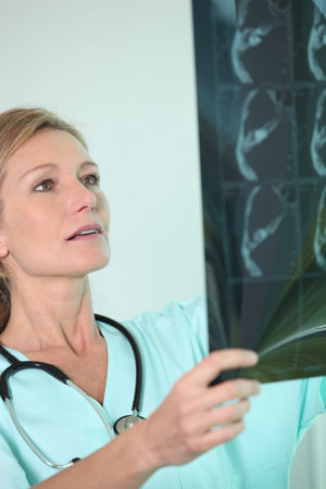 Nurse looking at X-ray