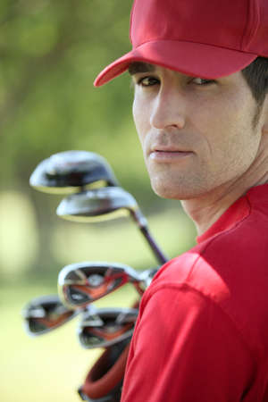 Golfer holding golf clubs.の写真素材