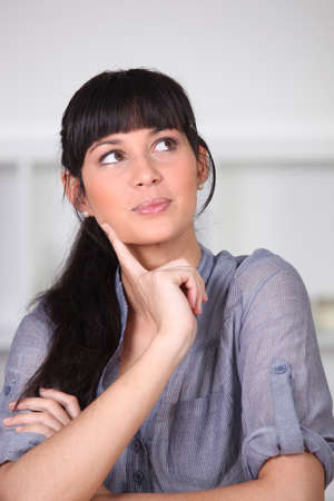 young woman wonderingの写真素材