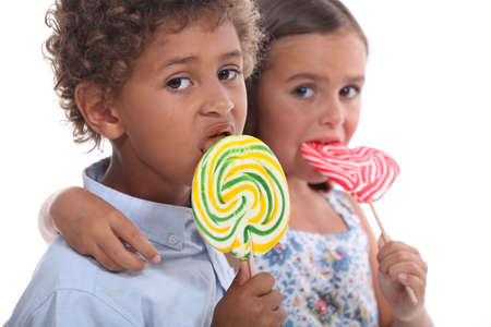 couple of children with lollypops couple of children with lollypops