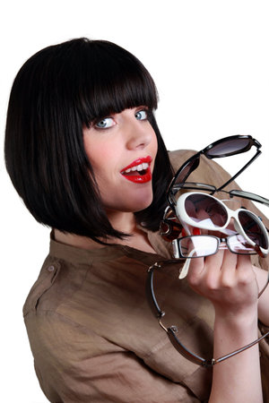 Woman with many pairs of sunglassesの写真素材