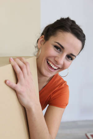 Woman moving belongings into new homeの写真素材