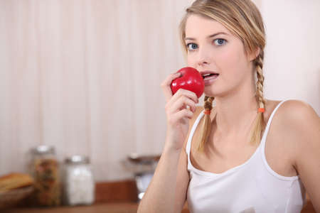 woman eating an appleの写真素材