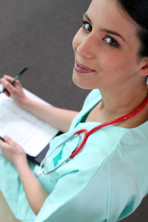 Female doctor taking notesの写真素材