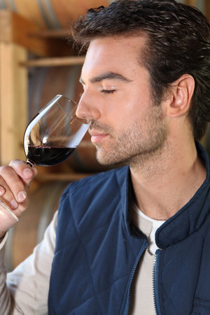 Man smelling red wine fragrancesの写真素材