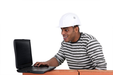 Young mason with computer