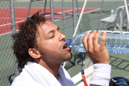 Tennis player having a drinkの写真素材