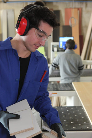 Two men sawing wood