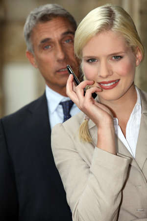 Young woman smiling with mobile phone in handの写真素材