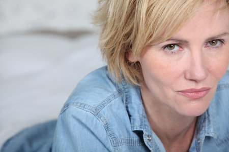 Landscape of blonde woman wearing denim shirt