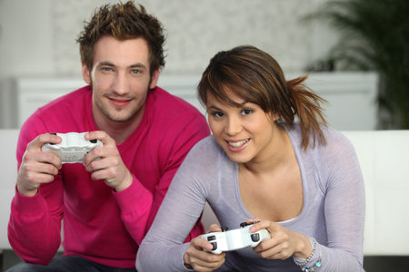 Young couple playing a games console