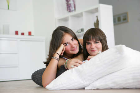 Teens supported on cushionsの写真素材