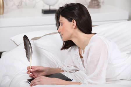 Woman writing with a featherの写真素材