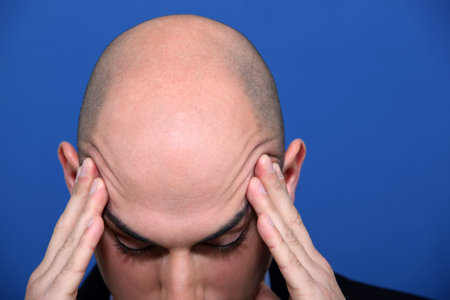 Bald executive under pressure