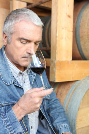 Man smelling red wine