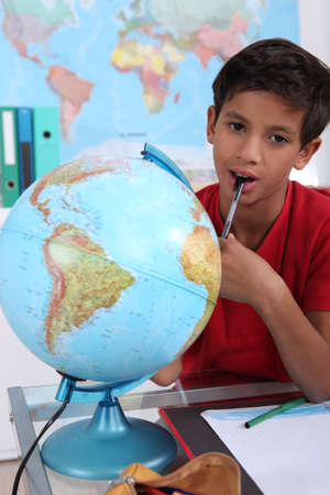 Little boy in classroom, looking boredの写真素材