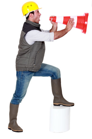 Young man screaming in a traffic coneの写真素材