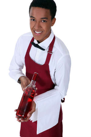 Waiter with bottle of rose wineの写真素材