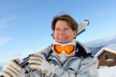 Older woman skier outside a chaletの写真素材