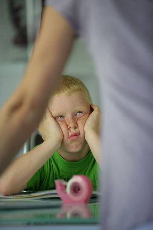 little boy in the classroom looking bored