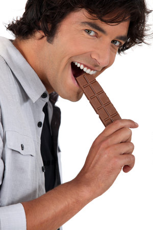 Man eating chocolateの写真素材