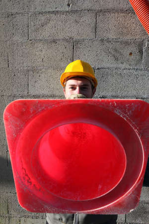 Builder holding traffic coneの写真素材