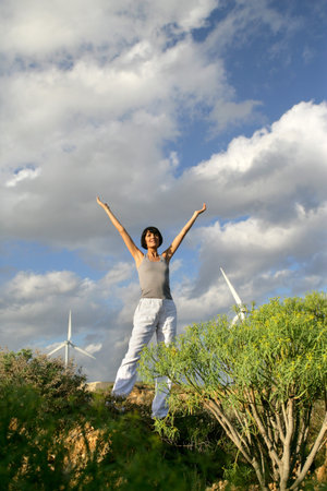 Woman stood in wind farm
