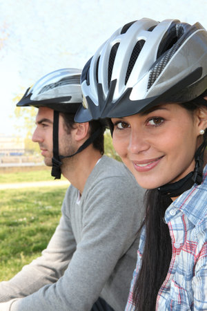 Young couple wearing cycle helmetsの写真素材