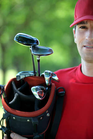 Golfer holding golf bag.の写真素材