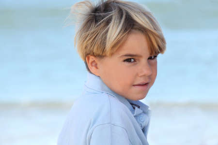 Little boy relaxing at the beachの写真素材