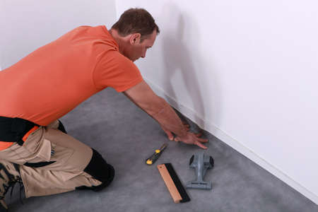 man installing linoleumの写真素材