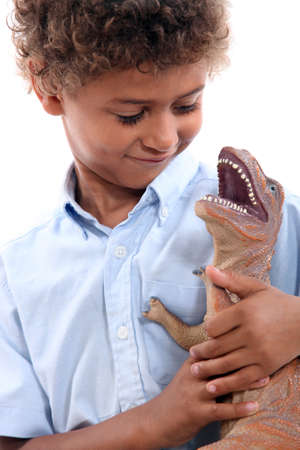 Little boy playing with a dinosaurの写真素材