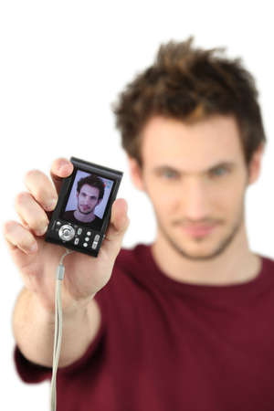 Man showing his portrait on cameraの写真素材