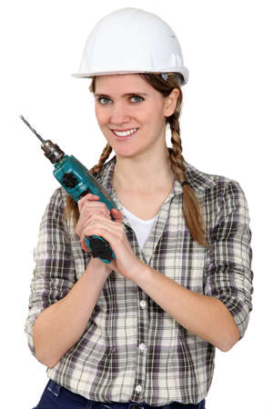 Tradeswoman holding a power toolの写真素材