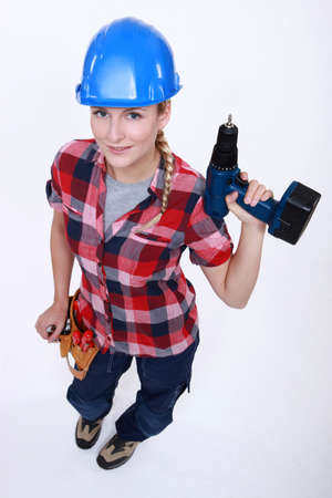 young craftswoman holding a drillの写真素材