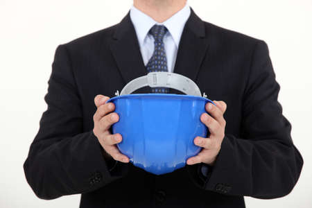 Architect holding hard hatの写真素材