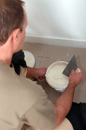 a man spreading a coating